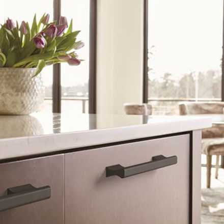 Amerock Status Collection in Black Displayed on Cabinets