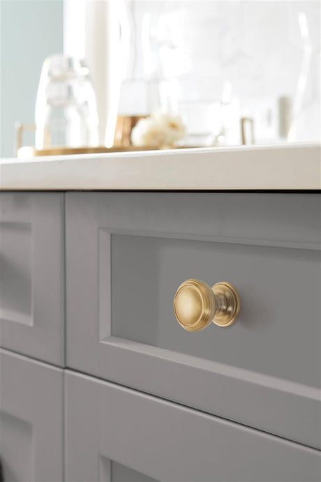 AMEROCK Revitalize 1-1/4" Diameter Cabinet Knob in Golden Champagne BP55342BBZ on Gray