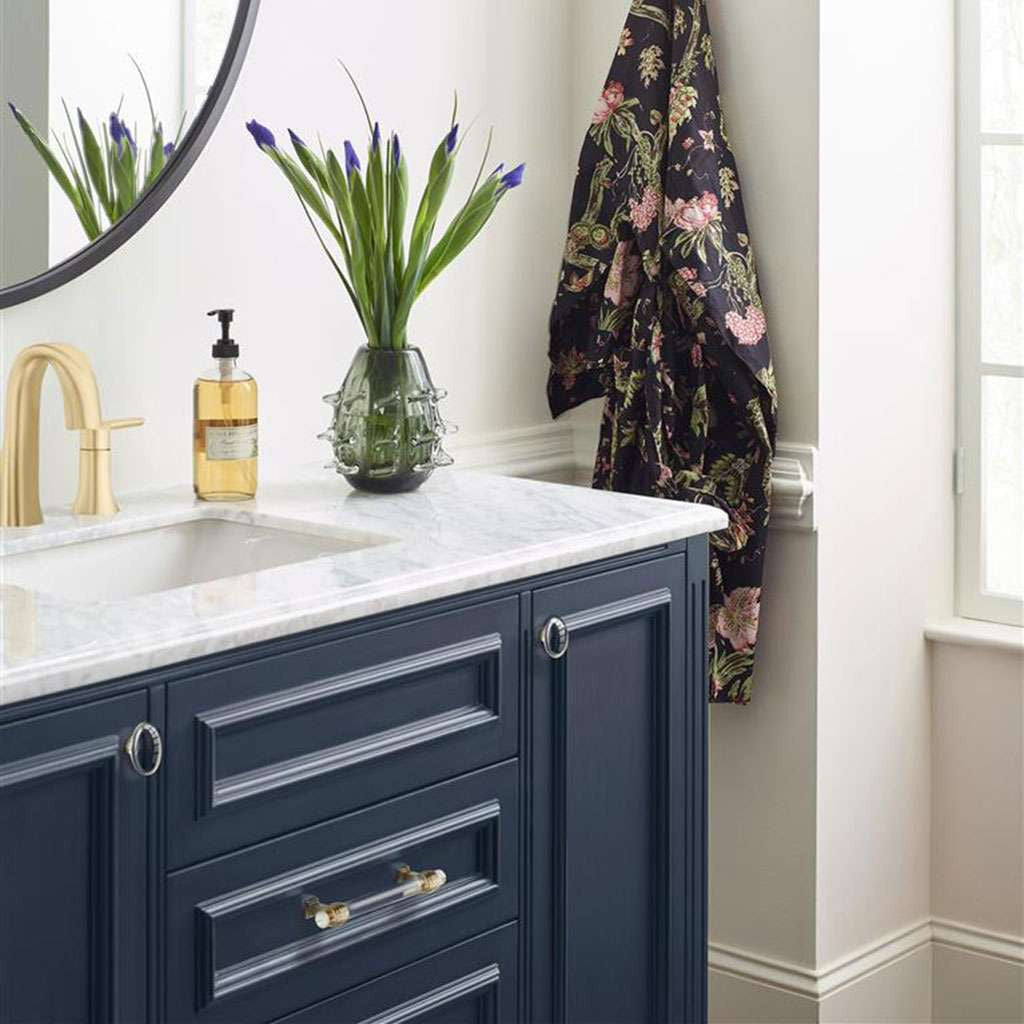 AMEROCK Glacio 1-3/4" Length Glass Oval Cabinet Knob in Clear and Golden Champagne BP36651CBBZ on Blue