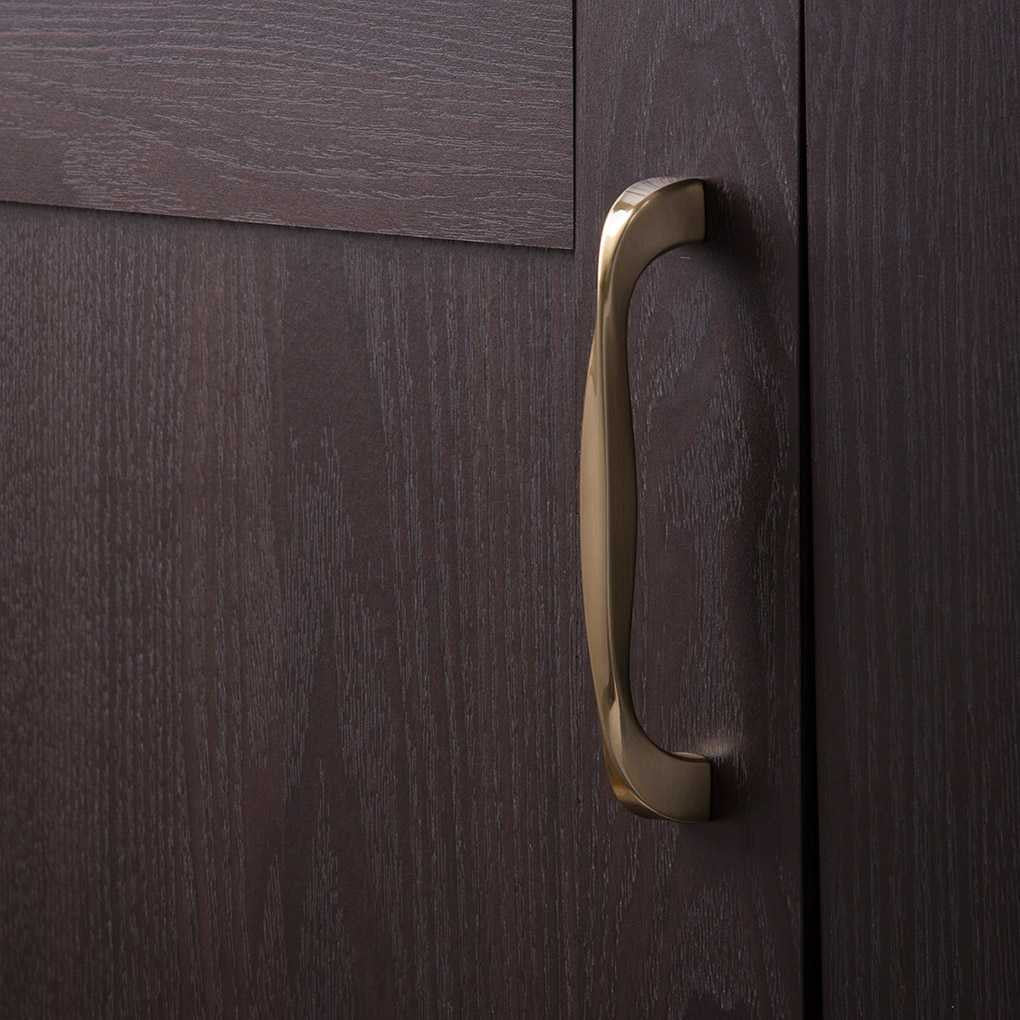 Cupboard View of a Golden Nickel 5-1/16" Hole Centers Cabinet Handle Pull from Hickory Hardware's Twist Collection H076017-EGN